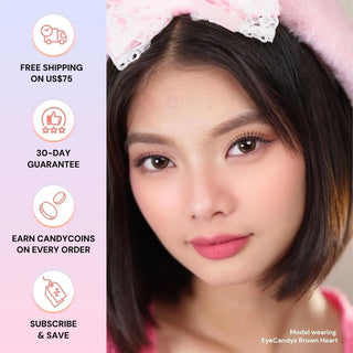 Model’s face with long lashes and natural makeup wearing EyeCandys Brown Heart colored contact lens – beige-brown heart-shaped design provides subtle iris enlargement, natural coverage, and a warm, romantic sparkle.