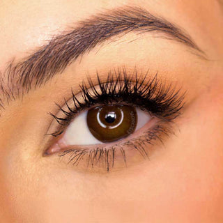 Pink Label Pointe Choco color contact lens on top of a dark eye paired with subtle eye makeup and curled wispy eyelashes