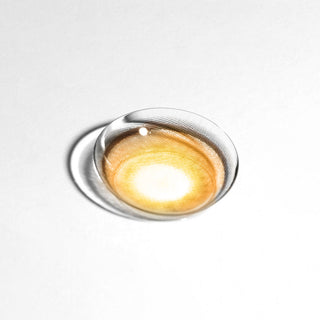 Macro shot of EyeCandys PowerGlow Brown contact lens, showing ultra-vibrant orange-brown pigmentation, defined iris, and full-coverage color for cosplay and bold looks.