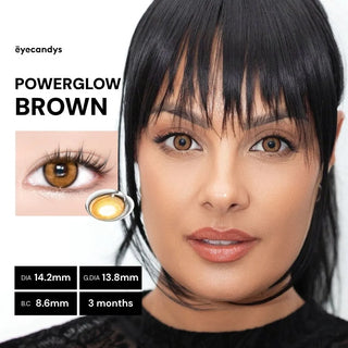 Model wearing EyeCandys PowerGlow Brown cosplay contact lenses, ultra-vibrant orange-brown color, full-coverage on dark eyes, defined iris, UV protection, and all-day comfort with MPC polymer.