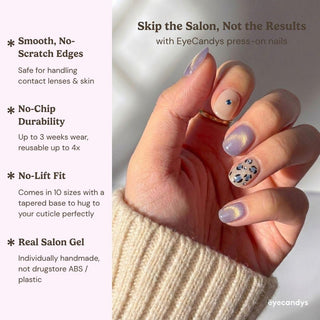 A hand shows off EyeCandys’ Purr-ple Reign Press-On Nails in pink, purple, nude, and animal prints against sunlight. Salon gel manicure offers smooth edges, no-chip durability, no-lift fit, and handmade gel quality.