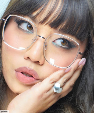 Model wearing Eyecandys Rini Oversized Square Glasses – Stylish oversized square eyeglasses in gold, designed for bold, confident looks, flattering on round and oval face shapes.