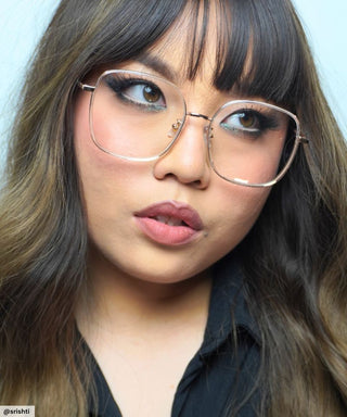 Model wearing Eyecandys Rini Oversized Square Glasses – Stylish oversized square eyeglasses in gold, designed for bold, confident looks, flattering on round and oval face shapes.