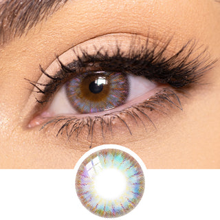 Close-up view of a model's eye featuring Rio Brown color contact lens with prescription, paired with neutral eye makeup, above a cutout of the contact lens showcasing the detailed starburst design.