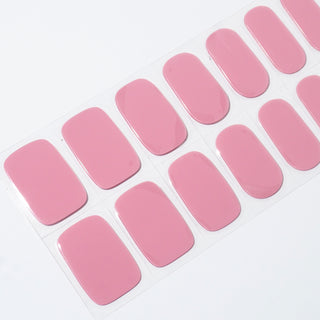 Angled image of semi-cured gel nail stickers in the design 'Shortcake,' featuring a soft pink color perfect for a sweet and feminine manicure.