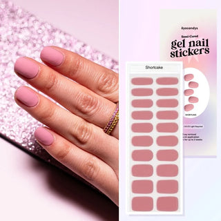 Hand with EyeCandys Shortcake Gel nail stickers applied, featuring a soft pink color. Perfect for DIY manicures, providing long-lasting, vibrant gel nail designs with easy application and a salon-quality finish