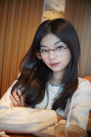 Trendy woman wearing EyeCandys Starlight blue light blocking glasses, designed with Zeiss HMC and photochromic lenses to reduce digital eye strain and glare