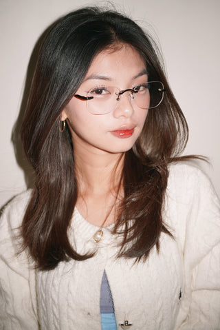 Young woman wearing EyeCandys Starlight prescription glasses, available in blue light blocking, Zeiss HMC, and photochromic lenses for all-day eye protection