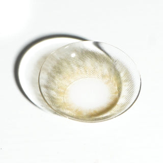 High quality macro shot flatlay of EyeCandys Sugarlook Brown Contact lens in a plain white backdrop showing the details of the lens