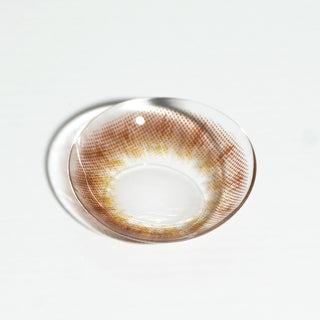 High quality macro shot flatlay of EyeCandys Truffle Brown Contact lens in a plain white backdrop showing the details of the lens