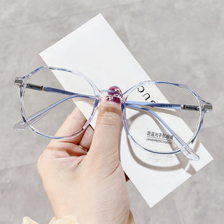 Elegant Blue glasses on a white surface, representing EyeCandys Vera Round vintage frames with Blue Light Blocking, Transitions and polarized options
