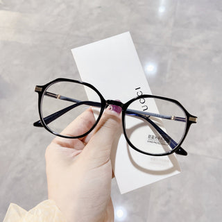 Elegant Black glasses on a white surface, representing EyeCandys Vera Round vintage frames with Blue Light Blocking, Transitions and polarized options
