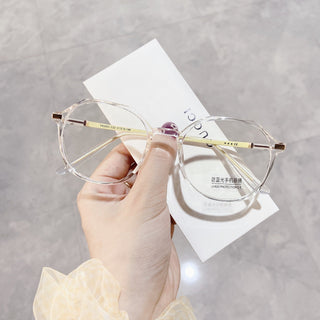 Elegant clear glasses on a white surface, representing EyeCandys Vera Round vintage frames with Blue Light Blocking, Transitions and polarized options
