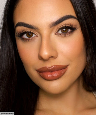 A female model with natural dark eyes wearing Pink Label Vintage grey contact lenses, complemented by subtle eyeshadow and peach lip gloss and Close-up image showcases the model's eyes adorned