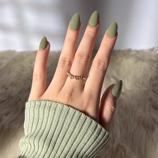 Hand wearing EyeCandys Avo-cat-o Gel Nail Sticker – soft avocado green nails with a creamy finish. Chic and modern DIY gel manicure perfect for everyday elegance or subtle statement nails. Vegan, non-toxic, and long-lasting.