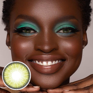 Dark-skinned model wearing the Desire Green colour contact lens for astigmatism on her naturally black eyes, paired with bright turquoise eyeshadow, next to a cutout of the contact lens design.