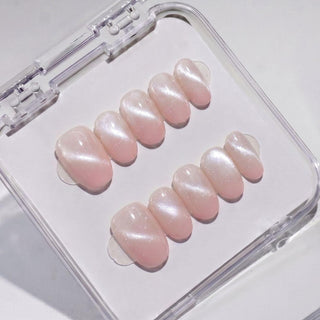 EyeCandys Bloom n Fade press on nails featuring champagne cat-eye nails fading into sheer petal pink tips with a soft glossy finish in short oval shape.