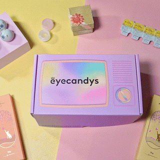 Animation showing EyeCandys color contact lens packaging, showing a colorful box that houses 5 pairs of colored contacts. The box is pink and purple themed and features cute cartoon illustrations of rabbits with large eyes.