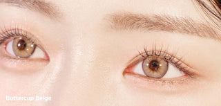 A close-up of a model demonstrating a natural makeup look with Ann365 Buttercup 1-Day Beige (10pk) circle colour contacts, highlighting how well the contact lenses blend with her dark eyes.