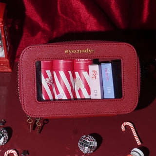 Festive red EyeCandys Holiday Essentials Case, compact and structured, perfect for winter trips and year-end plans.