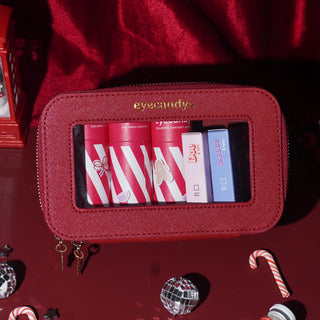 Festive red EyeCandys Holiday Essentials Case, compact and structured, perfect for winter trips and year-end plans.