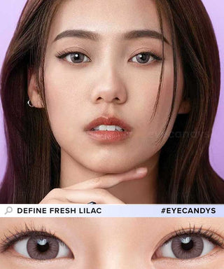 A female model with natural dark eyes wearing Define Fresh Lilac contact lenses, complemented by subtle eyeshadow and peach lip gloss and Close-up image showcases the model's eyes adorned with the same purple contact lenses