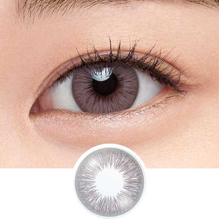 Define Fresh Lilac color contact lens on top of a dark eye paired with subtle eye makeup and curled wispy eyelashes, above the contact lens design.