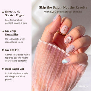 Detailed view of Eyecandys Charmed, I'm Sure press-on nails highlighting a sculpted gold cherry charm, blue stars, champagne glitter, plaid artwork, and silver chrome nail.