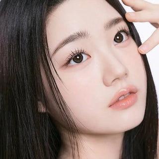 Model with natural makeup wearing EyeCandys I-Girl One Pick Natural Beige contact lenses for a subtle eye enhancement