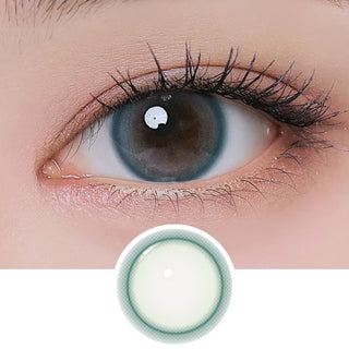 Close-up of eye with long lashes wearing EyeCandys I-Girl One Pick Natural Soda contact lens, showing detailed lens design below