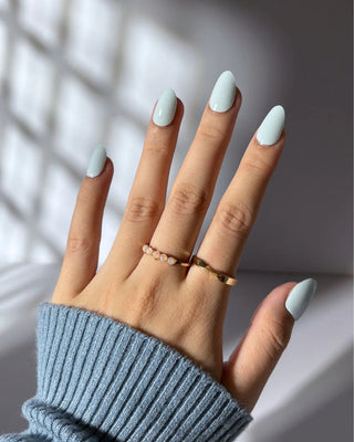 Model’s hand wearing EyeCandys Mint Condition Gel Nail Sticker Set – pastel creamy mint green manicure that’s fresh, chic, and perfect for spring or summer. Non-toxic, vegan gel nail stickers with salon-quality shine and long-lasting wear.