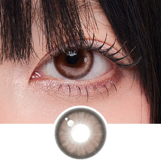Close-up shot of model's eye adorned with Zoe Brown prescription circle contact lenses, complemented by clean eye makeup, showing the brightening effect of the prescription cosmetic contact lens on dark brown eyes.