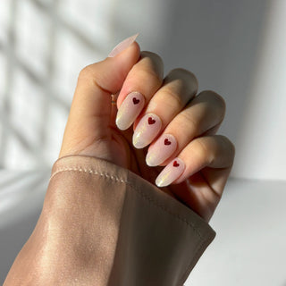 Hand with EyeCandys "Don't Play With My Heart" glitter gel nail sticker, showing sparkling heart nail art for DIY manicures.