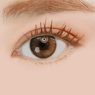 Macro shot of an eye wearing the i-Sha 1-Day Oriana Shade Grey (10pk) prescription colour contact lens, showing the multi-colored detail and natural effect on dark brown eyes.