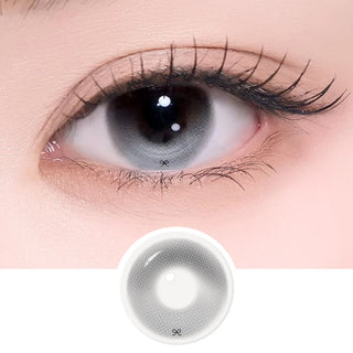 Extreme close-up of an eye wearing a gray patterned contact lenses with intricate design and a matching lens swatch below.