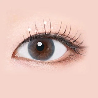 Macro shot of an eye wearing the i-Sha Serenity 1-Day Grey (10pk) prescription colour contact lens, showing the multi-colored detail and natural effect on dark brown eyes.