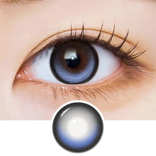 Close-up of an eye with long lashes wearing EyeCandys i-Sha Dekame Kiss Me 1-Day Blue Pop colored contact lenses, showing the lens design pattern