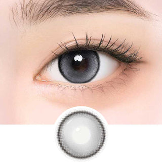 i-Girl IG Cat Grey color contact lens on top of a dark eye paired with subtle eye makeup and curled wispy eyelashes, above the contact lens design.
