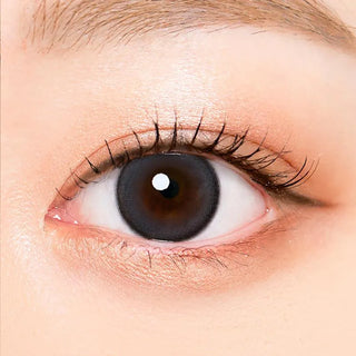 Macro shot of an eye wearing the i-Sha Oriana Mune 1-Day Grey (10pk) prescription colour contact lens, showing the multi-colored detail and natural effect on dark brown eyes.