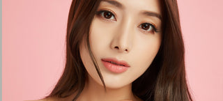Model wearing eye-enlarging colored contacts for astigmatism, showing the natural the cute effect on her dark brown eyes, with simple eye makeup.