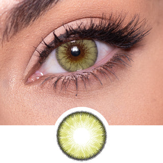 Close-up shot of a model eye wearing Desire Lush Green colored contact lens in one eye that is naturally dark-brown with natural rosegold eye make up