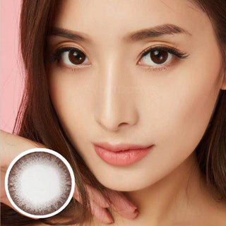 Model with natural makeup wearing EyeCandys Neo Chocolate Brown prescription contact lens, with the lens design shown below. The lenses provide a warm, rich brown tone, enhancing natural eye color for a subtle, vibrant look. Perfect for individuals seeking prescription colored contact lenses, these lenses offer comfort and a natural enhancement for dark eyes