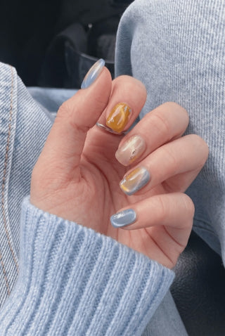 Amber Alert press-on nails worn on hand