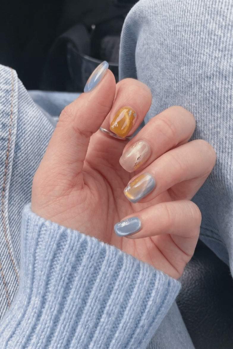 Amber Alert press-on nails worn on hand