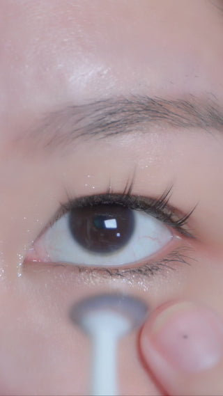 Applying the Chole Blue dolly circle contact lens on a naturally dark eye using a lens applicator tool, showing the opacity of the bright blue contact lens from various angles.