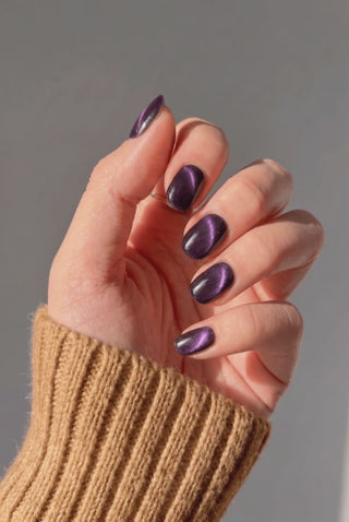 EyeCandys Nightshade press-on nails featuring a dark and elegant manicure on a hand