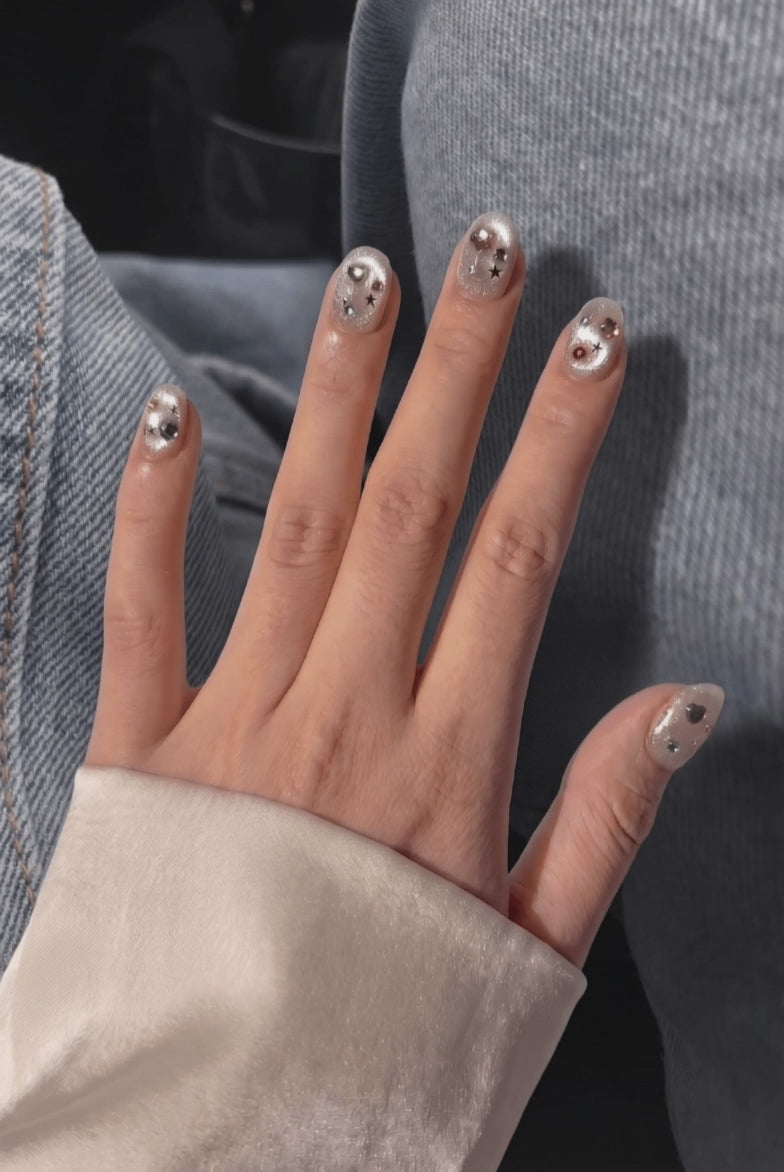 Gem-maxxed press-on nails worn on hand