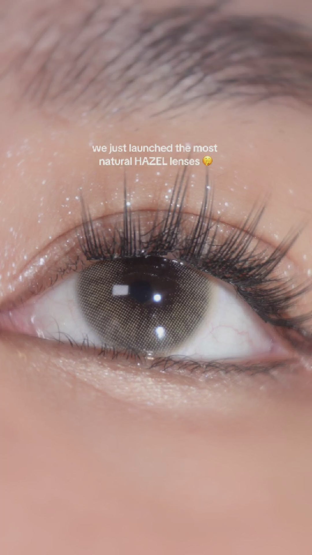 Close-up video of a model applying EyeCandys Glossy Hazel contact lenses, the most natural hazel lenses. Side-by-side comparison of the eye with and without lenses, showcasing the subtle yet enhancing effect