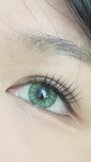 Desire Green prescription colour contact lens worn on a naturally dark iris with natural eyelashes and makeup.