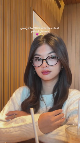 Model with long wavy hair wearing EyeCandys Chase Round Oval prescription reading glasses, featuring blue light blocking lenses for eye strain relief and stylish all-day comfort.